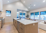Thumbnail 8 of 82 - A modern kitchen with wooden cabinets and a large island.