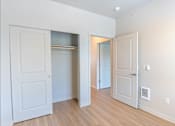 Thumbnail 78 of 82 - A white door is open to a hallway.