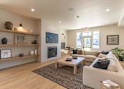 Thumbnail 1 of 51 - A living room with a fireplace and a couch at Cascade Place Apartment Homes, Oregon