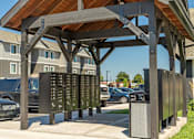 Thumbnail 14 of 51 - A wooden structure with a metal signboard underneath it at Cascade Place Apartment Homes, Molalla, OR, 97038