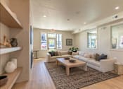 Thumbnail 2 of 51 - A living room with a couch, coffee table, and a television at Cascade Place Apartment Homes, Oregon, 97038