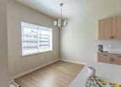 Thumbnail 26 of 51 - A dining room with a table set for two at Cascade Place Apartment Homes, Molalla, Oregon