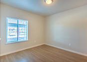 Thumbnail 31 of 51 - A room with a window and wooden flooring at Cascade Place Apartment Homes, Molalla, OR