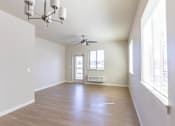 Thumbnail 35 of 51 - A room with a ceiling fan and a chandelier at Cascade Place Apartment Homes, Molalla, 97038