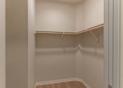 Thumbnail 42 of 51 - A small, empty closet with a wooden floor and white walls at Cascade Place Apartment Homes, Oregon, 97038