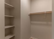 Thumbnail 43 of 51 - A white closet with shelves and a hanger at Cascade Place Apartment Homes, Molalla, 97038