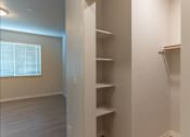 Thumbnail 44 of 51 - A white closet with shelves and a window at Cascade Place Apartment Homes, Oregon