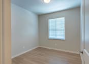 Thumbnail 50 of 51 - A room with a window and wooden flooring at Cascade Place Apartment Homes, Oregon, 97038