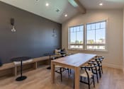 Thumbnail 8 of 51 - A dining room with a wooden table and chairs at Cascade Place Apartment Homes, Molalla, OR