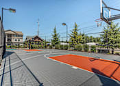 Thumbnail 2 of 36 - A basketball court with a basketball hoop and a backboard at Forestplace Apartment Homes, Oregon