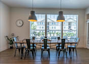 Thumbnail 27 of 36 - A dining room with a table and chairs at Forestplace Apartment Homes, Forest Grove, Oregon