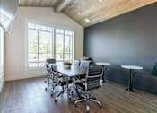 Thumbnail 29 of 36 - A conference room with a long table and chairs at Forestplace Apartment Homes, Forest Grove, OR, 97116