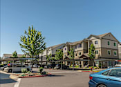 Thumbnail 3 of 36 - A blue car is parked in a parking lot in front of a building at Forestplace Apartment Homes, Oregon, 97116