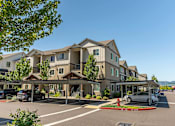 Thumbnail 4 of 36 - A row of houses with a car parked in front of them at Forestplace Apartment Homes, Forest Grove, OR, 97116