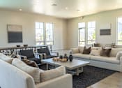 Thumbnail 1 of 25 - A living room with a white couch, black chairs, and a coffee table at Northplace Apartment Homes, Salem, OR