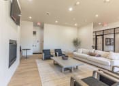 Thumbnail 10 of 25 - A living room with a white couch, a black television, and a wooden coffee table at Northplace Apartment Homes, Oregon
