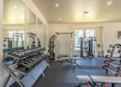 Thumbnail 16 of 25 - A well-equipped gym with mirrors on the wall at Northplace Apartment Homes, Salem
