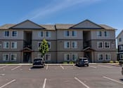 Thumbnail 19 of 25 - A large building with a parking lot in front of it at Northplace Apartment Homes, Oregon