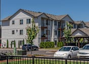 Thumbnail 20 of 25 - A row of townhouses with cars parked in front at Northplace Apartment Homes, Salem, Oregon