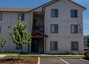 Thumbnail 22 of 25 - A building with a parking lot in front of it at Northplace Apartment Homes, Salem, Oregon