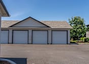 Thumbnail 24 of 25 - A building with a brown roof and white garage doors at Northplace Apartment Homes, Salem, OR