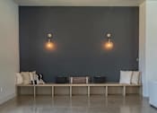 Thumbnail 4 of 25 - A room with a bench and two lights on the wall at Northplace Apartment Homes, Salem, Oregon