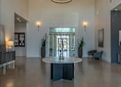 Thumbnail 7 of 25 - A large, round table sits in the middle of a spacious room with a glass wall behind it at Northplace Apartment Homes, Salem, OR