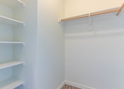 Thumbnail 11 of 72 - A white pantry with shelves and a white wall at Riverplace Apartment Homes, Independence, OR, 97351