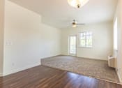 Thumbnail 14 of 72 - A room with a ceiling fan and a rug on the floor at Riverplace Apartment Homes, Oregon, 97351