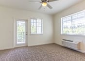 Thumbnail 15 of 72 - A room with a ceiling fan and a window with blinds at Riverplace Apartment Homes, Independence, OR
