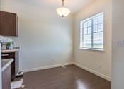 Thumbnail 2 of 72 - A room with a window and a hanging light fixture at Riverplace Apartment Homes, Oregon
