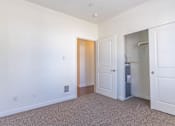 Thumbnail 24 of 72 - A white room with a door and a small cabinet at Riverplace Apartment Homes, Independence, OR, 97351