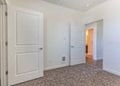 Thumbnail 27 of 72 - A white door is open to a hallway at Riverplace Apartment Homes, Independence, 97351