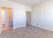 Thumbnail 29 of 72 - A large, empty room with carpeted flooring and white walls at Riverplace Apartment Homes, Independence, OR