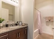 Thumbnail 3 of 72 - A bathroom with a sink, mirror, and towel rack at Riverplace Apartment Homes, Independence, 97351