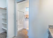 Thumbnail 30 of 72 - A white bathroom with a towel hanging on the door at Riverplace Apartment Homes, Oregon