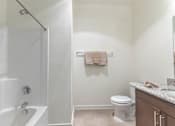 Thumbnail 33 of 72 - A white bathroom with a toilet, sink, and bathtub at Riverplace Apartment Homes, Oregon