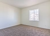 Thumbnail 4 of 72 - A room with a carpeted floor and a window at Riverplace Apartment Homes, Independence, 97351