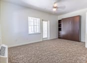 Thumbnail 41 of 72 - A room with a brown wardrobe and a window with blinds at Riverplace Apartment Homes, Independence, OR, 97351