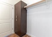 Thumbnail 43 of 72 - A brown wardrobe is in a white room at Riverplace Apartment Homes, Independence