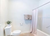 Thumbnail 44 of 72 - A white toilet sits next to a white sink in a bathroom at Riverplace Apartment Homes, Oregon