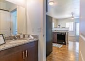 Thumbnail 45 of 72 - A kitchen with a granite countertop and a black refrigerator at Riverplace Apartment Homes, Independence, Oregon
