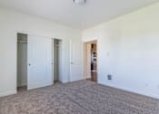 Thumbnail 5 of 72 - A room with carpeted floor and white walls with a doorway leading to another room at Riverplace Apartment Homes, Independence, 97351