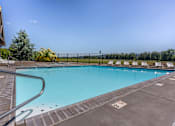 Thumbnail 54 of 72 - A large outdoor swimming pool with a metal ladder on the left side at Riverplace Apartment Homes, Oregon, 97351