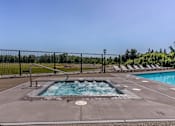 Thumbnail 55 of 72 - A pool with a hot tub in the middle of it at Riverplace Apartment Homes, Independence