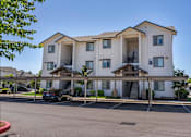 Thumbnail 62 of 72 - A large white apartment building with a car parked in front at Riverplace Apartment Homes, Oregon, 97351