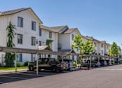 Thumbnail 71 of 72 - A row of houses with cars parked in front at Riverplace Apartment Homes, Independence, OR