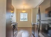 Thumbnail 8 of 72 - A kitchen with a refrigerator, stove, and oven at Riverplace Apartment Homes, Independence, OR