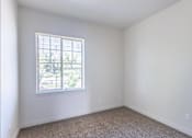 Thumbnail 1 of 28 - A room with a window and carpeted floor at Silverplace Apartment Homes, Silverton, OR, 97381