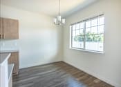 Thumbnail 13 of 28 - A room with a window and a kitchen area at Silverplace Apartment Homes, Oregon, 97381